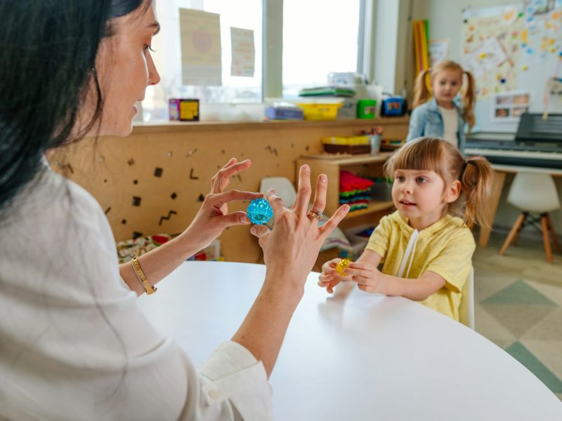 Girl on the lesson of the development of fine motor skills in kindergarten